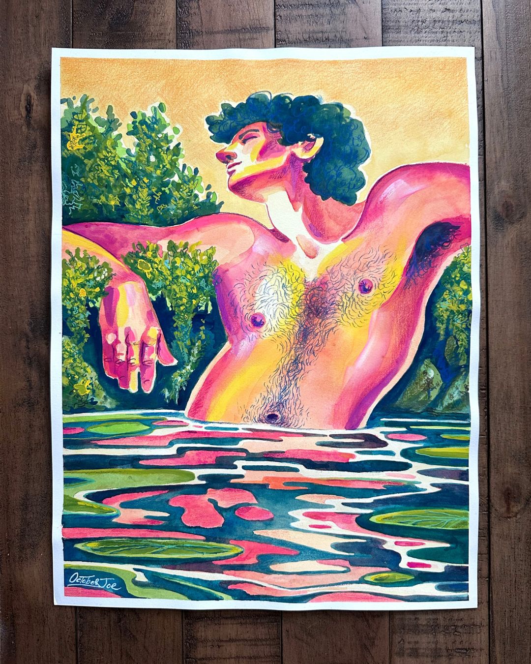 Colorful artwork of a nude figure in water with trees in the background on a wooden surface.