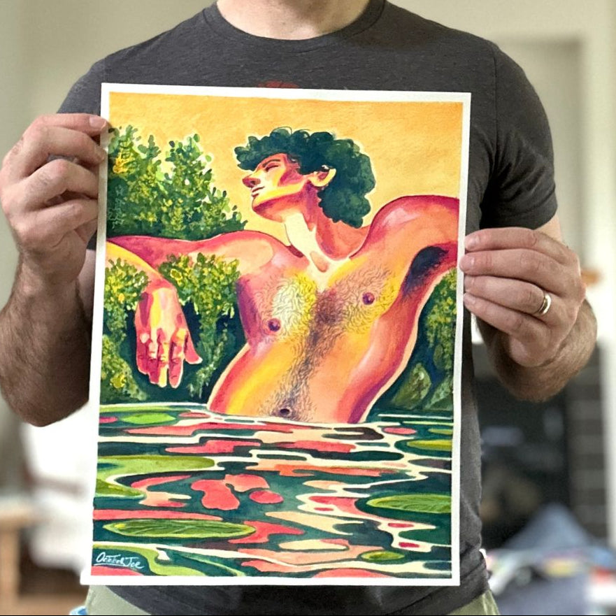 Man holding a colorful artwork of a nude figure by a pool